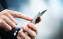 Close up of a man using mobile smart phone